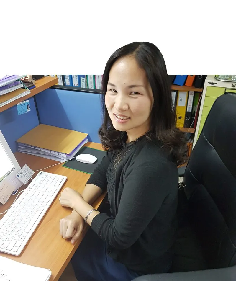 A member of the Assist team at her desk in the office